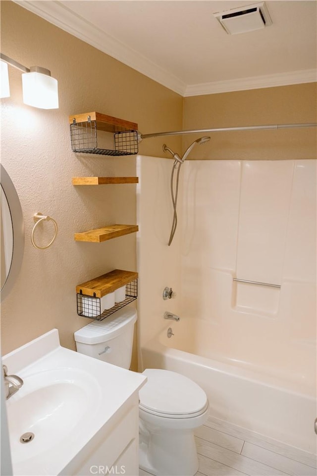 full bathroom with vanity, crown molding, toilet, and washtub / shower combination