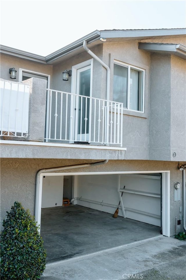 view of home's exterior with a balcony and a garage