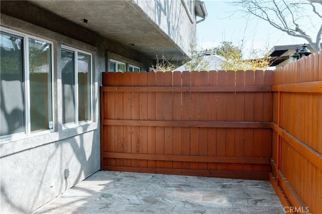 view of patio featuring fence