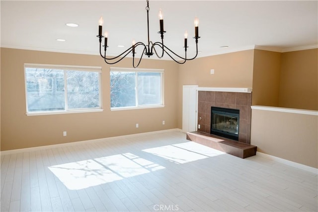 unfurnished living room featuring crown molding, a fireplace, and light wood-type flooring