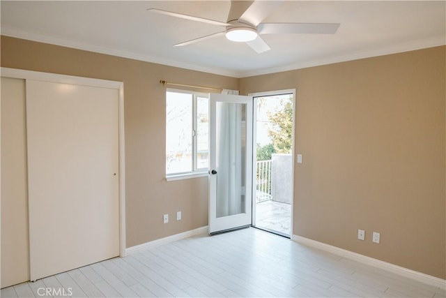 unfurnished bedroom with access to exterior, ceiling fan, crown molding, light wood-type flooring, and a closet