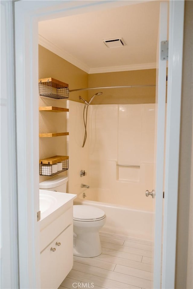 full bathroom with bathtub / shower combination, ornamental molding, vanity, and toilet