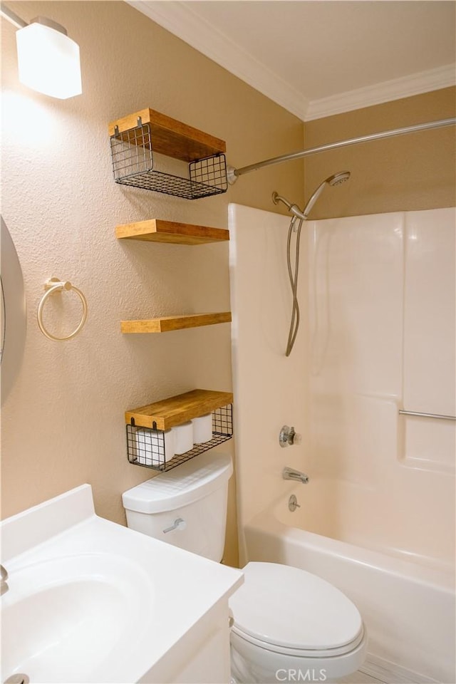 full bathroom featuring crown molding, sink, bathtub / shower combination, and toilet