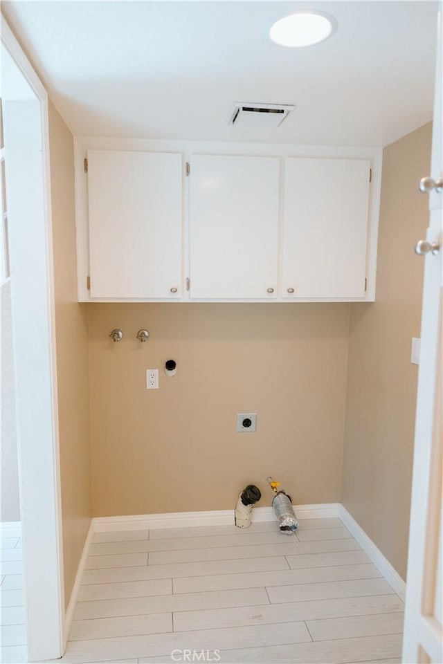 laundry area with visible vents, hookup for an electric dryer, baseboards, cabinet space, and washer hookup