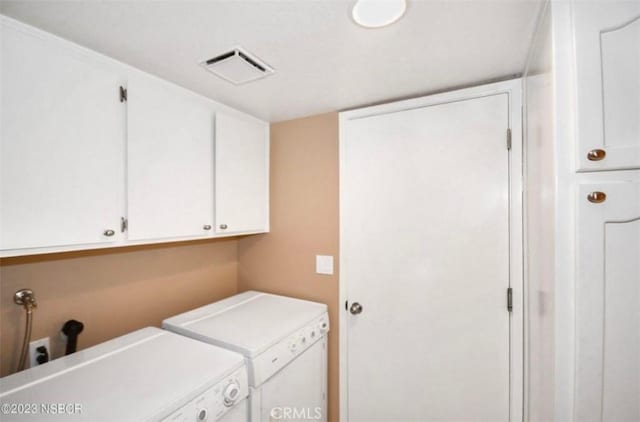 clothes washing area featuring cabinet space, washing machine and dryer, and visible vents