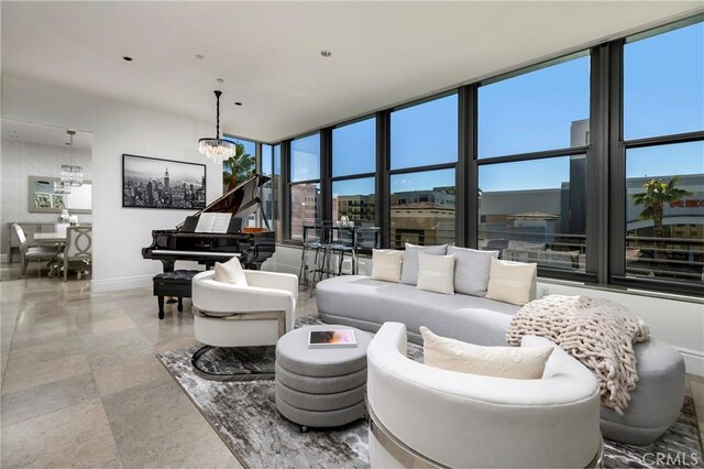 living room with expansive windows, a wealth of natural light, and a notable chandelier