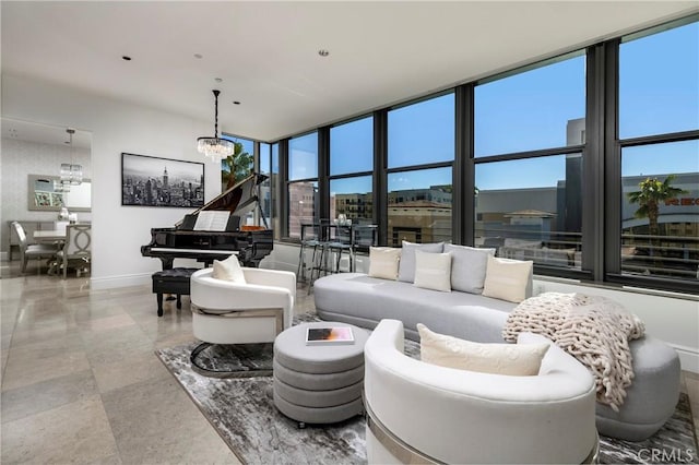 living room featuring an inviting chandelier and floor to ceiling windows