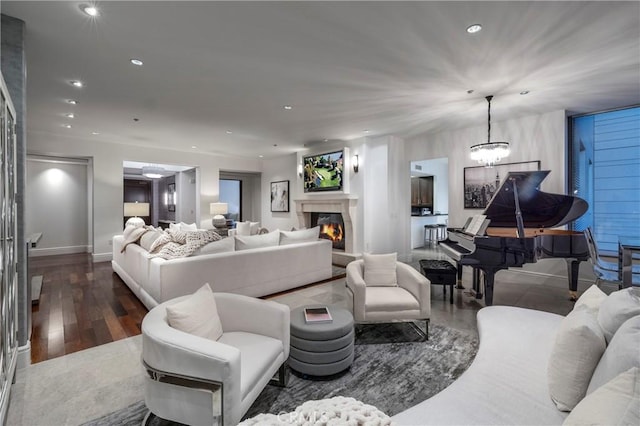 living room with dark wood-type flooring and a chandelier