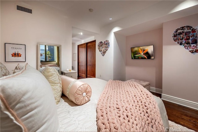 bedroom featuring dark wood-type flooring and a closet