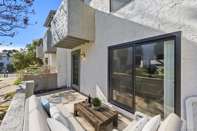 view of patio with a balcony and outdoor lounge area