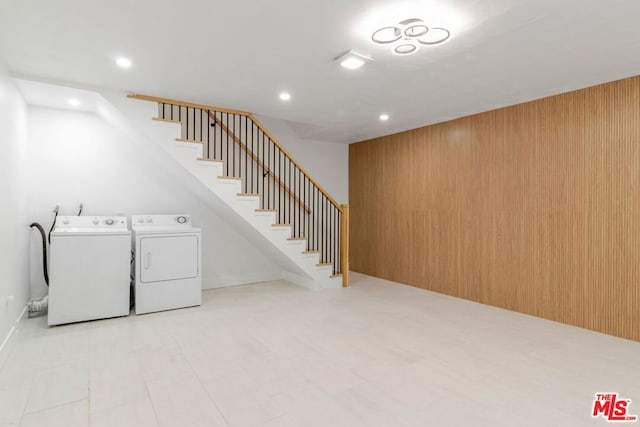 basement with independent washer and dryer and wooden walls