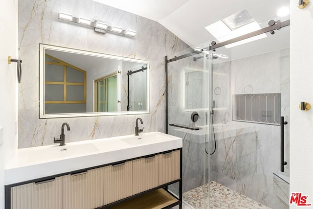 bathroom featuring vanity, a shower with shower door, and lofted ceiling with skylight