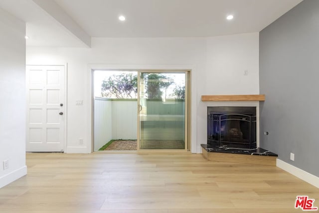 unfurnished living room featuring light hardwood / wood-style flooring