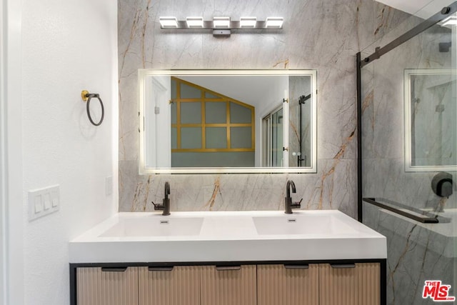 bathroom featuring vanity and a shower with shower door