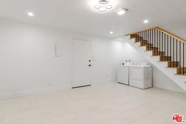 washroom with washing machine and clothes dryer