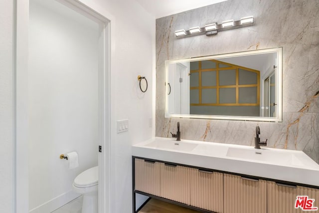 bathroom featuring vanity and toilet