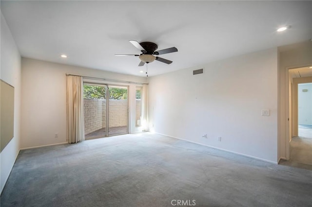 spare room with ceiling fan and carpet