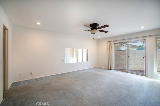 carpeted spare room with ceiling fan