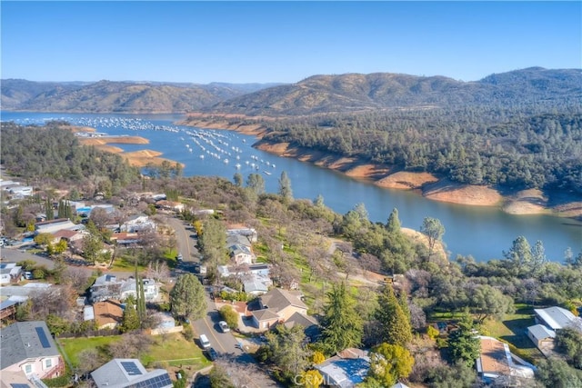 drone / aerial view featuring a water and mountain view