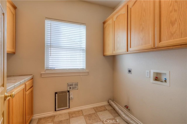 clothes washing area with gas dryer hookup, washer hookup, cabinets, and hookup for an electric dryer