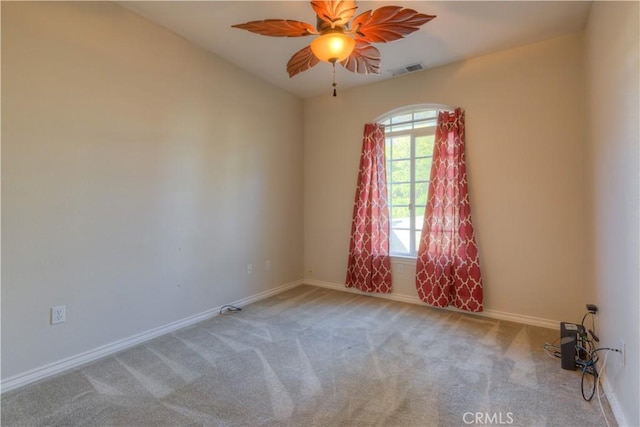 spare room featuring light carpet and ceiling fan