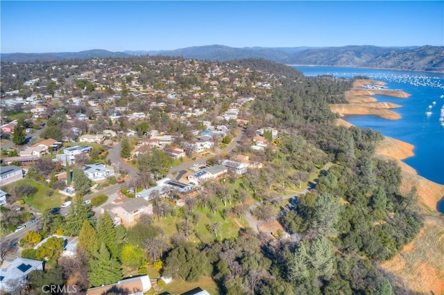 birds eye view of property with a water and mountain view