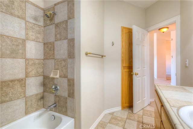 bathroom with vanity and tiled shower / bath combo