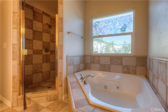 bathroom with plenty of natural light and separate shower and tub