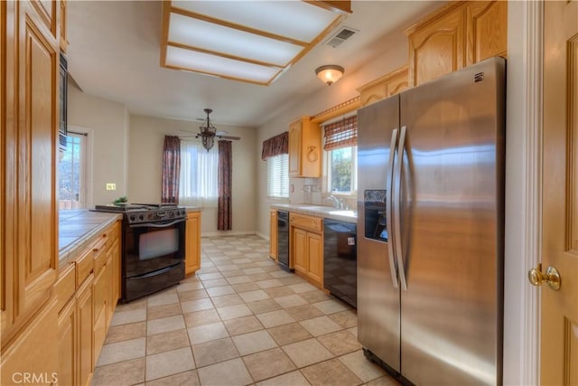 kitchen with ceiling fan, sink, light tile patterned floors, and black appliances