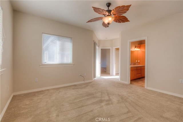 carpeted empty room featuring ceiling fan