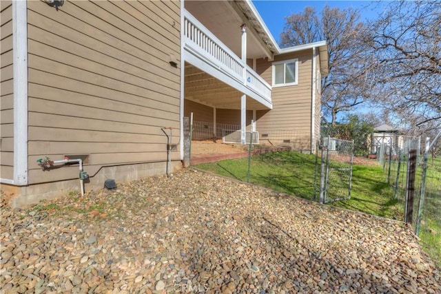 view of side of home featuring a balcony