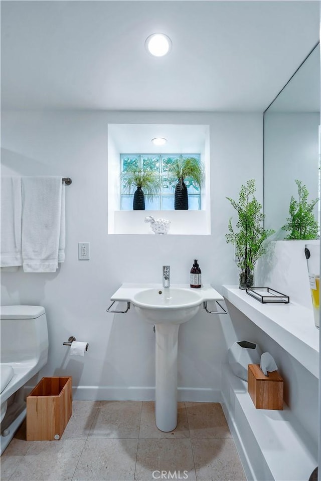 bathroom with tile patterned floors and toilet