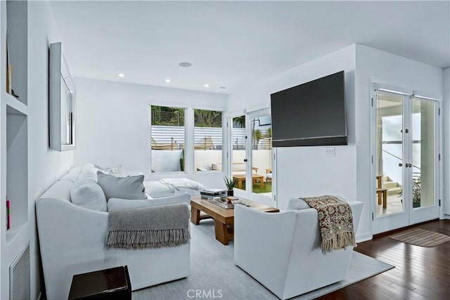 living room with hardwood / wood-style floors and french doors