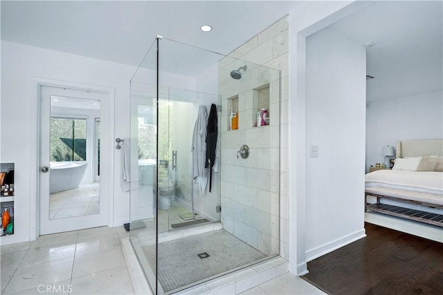 bathroom featuring shower with separate bathtub and tile patterned flooring