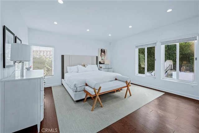 bedroom with dark hardwood / wood-style flooring