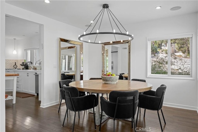 dining room featuring dark hardwood / wood-style floors and a chandelier