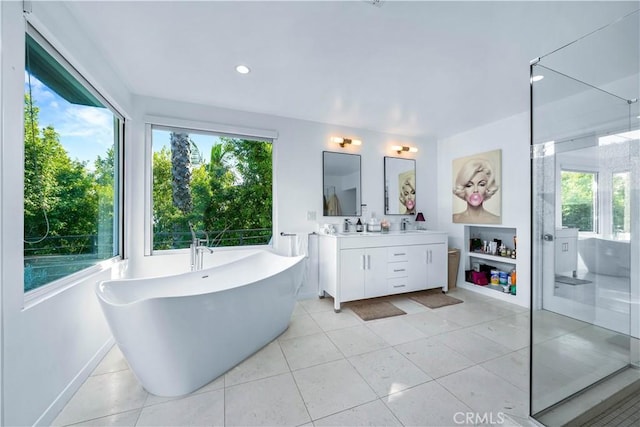 bathroom with tile patterned floors, vanity, and a bathtub