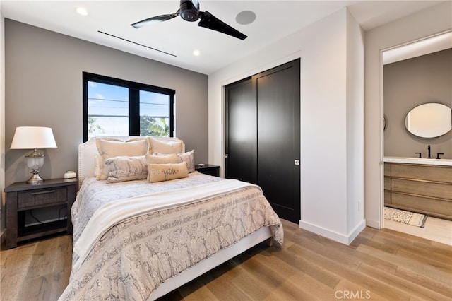 bedroom with light hardwood / wood-style flooring, a closet, and ceiling fan