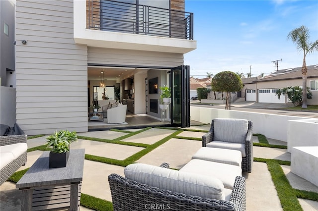 view of patio / terrace with an outdoor living space and a balcony