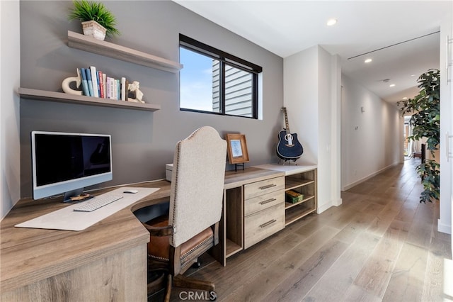 office space with hardwood / wood-style flooring and built in desk