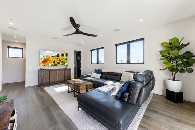 living room featuring ceiling fan, plenty of natural light, and hardwood / wood-style floors