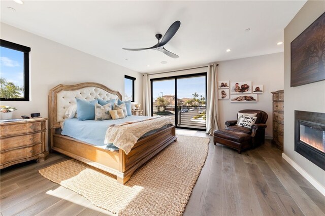 bedroom featuring wood-type flooring, access to outside, and ceiling fan