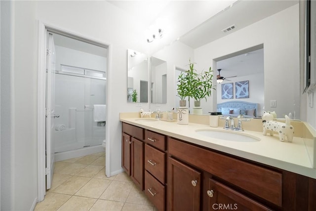 bathroom featuring ceiling fan, an enclosed shower, vanity, tile patterned floors, and toilet