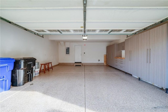 garage featuring a garage door opener and electric panel