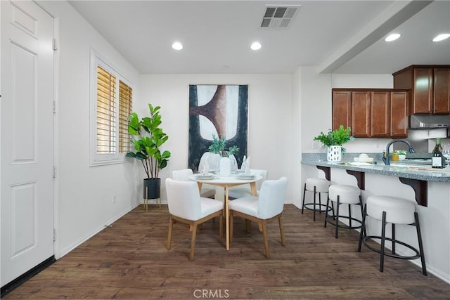 dining area featuring dark hardwood / wood-style flooring and sink