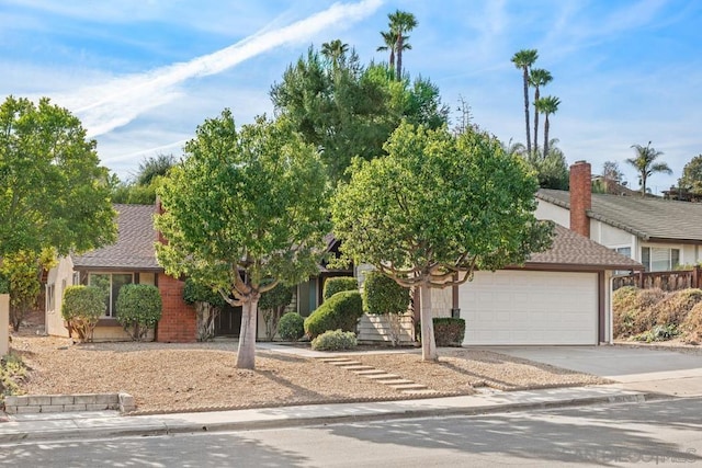 view of property hidden behind natural elements featuring a garage