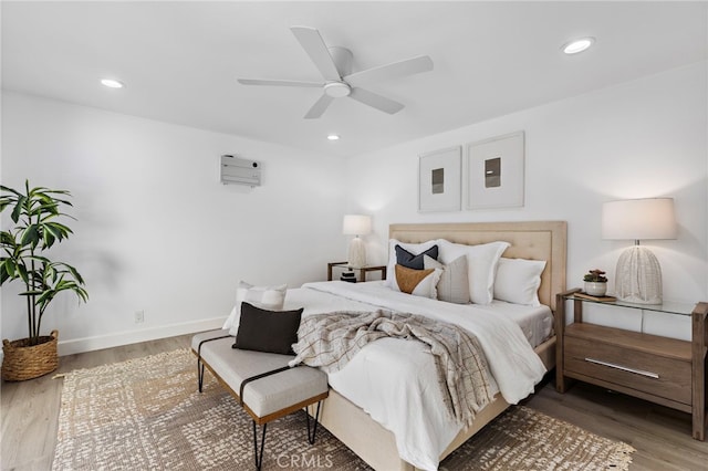 bedroom featuring ceiling fan, baseboards, wood finished floors, and recessed lighting