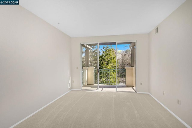 unfurnished room with light carpet