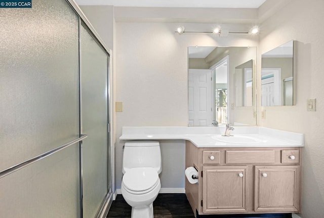 bathroom with vanity, toilet, and walk in shower