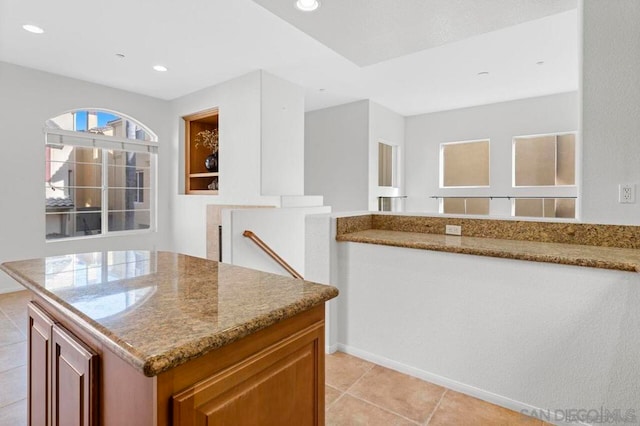 kitchen featuring light stone countertops and light tile patterned floors